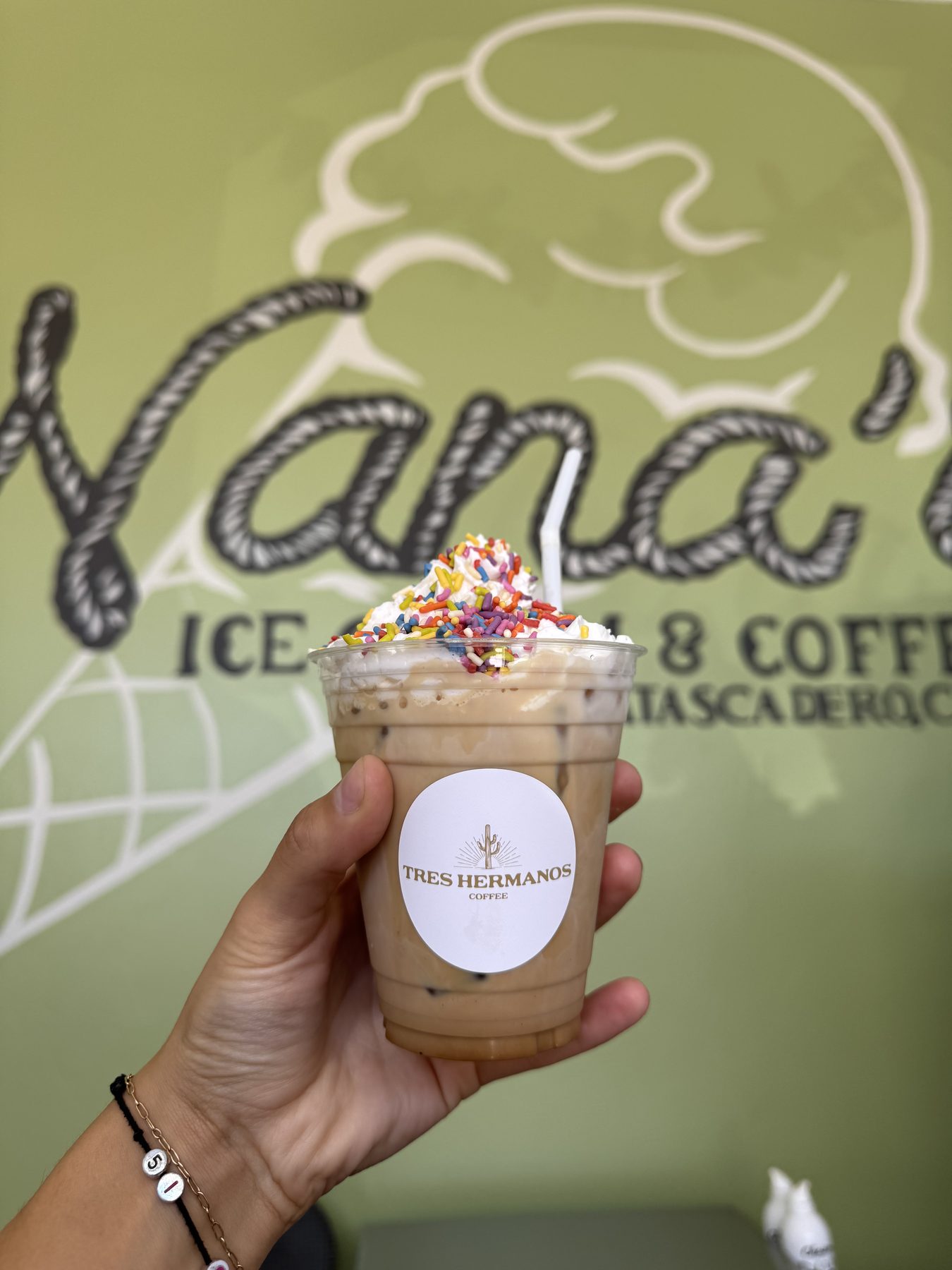 Iced latte with whipped cream and sprinkles at the Atascadero counter