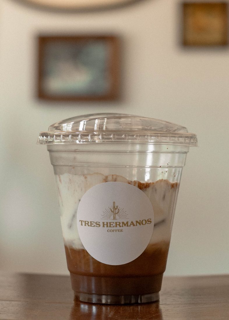 Coastal Cowgirl layered iced drink in a branded cup