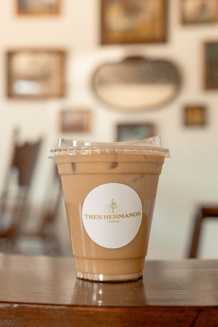 Tres Hermanos Latte in a branded cup