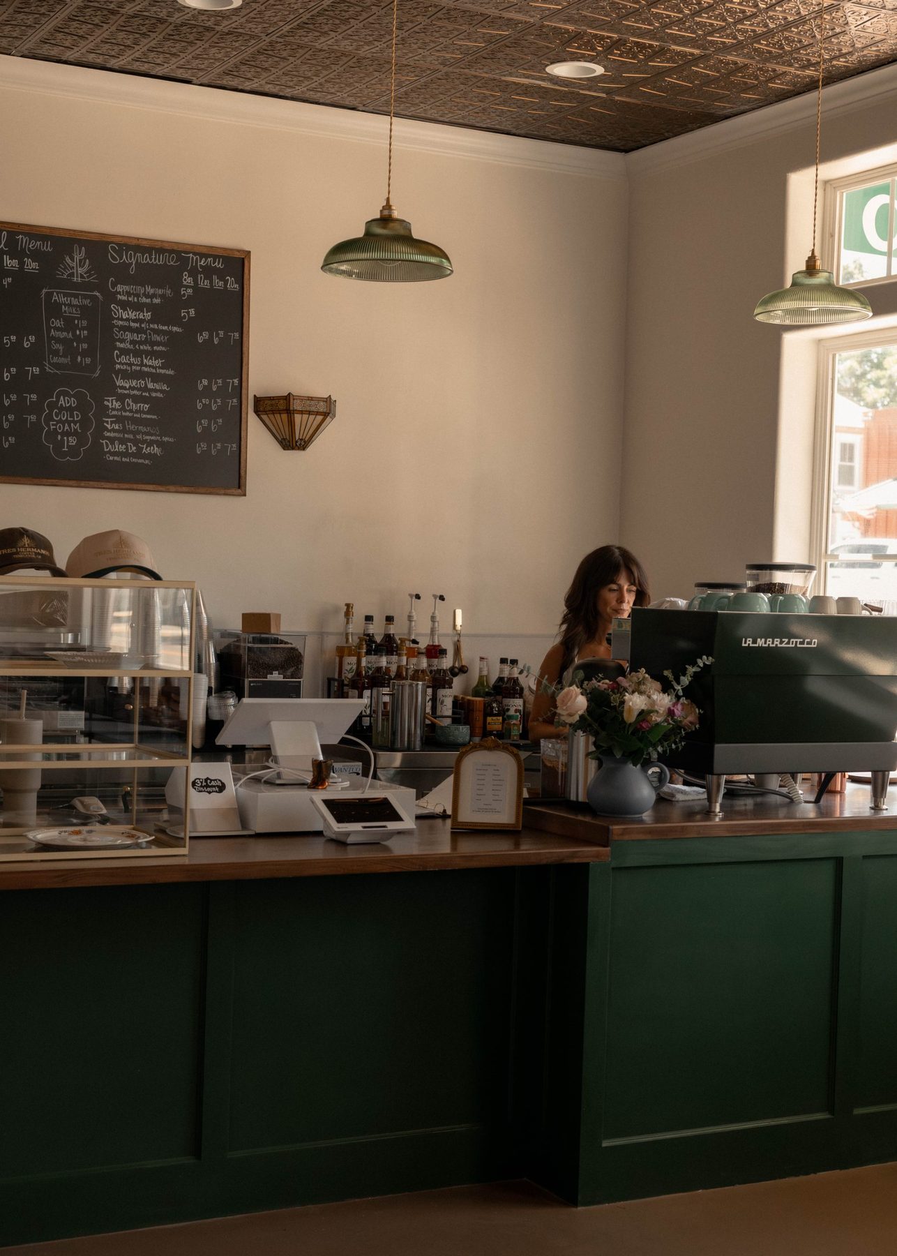 The green counter and chalkboard menu at Tres Hermanos